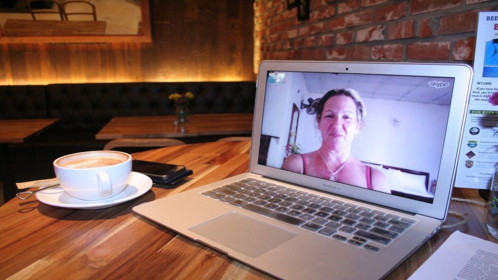woman on Skype call laptop