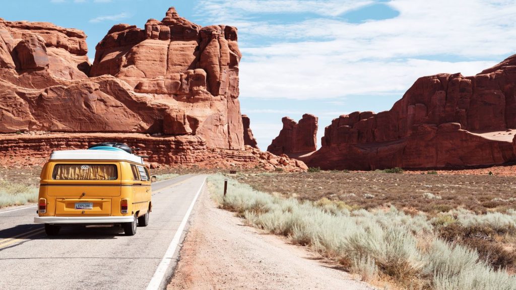 yellow van driving through Arches National Park