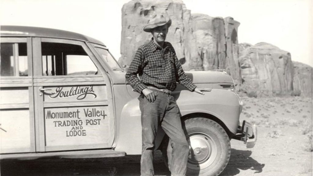 Harry Goulding standing with his car in Monument Valley