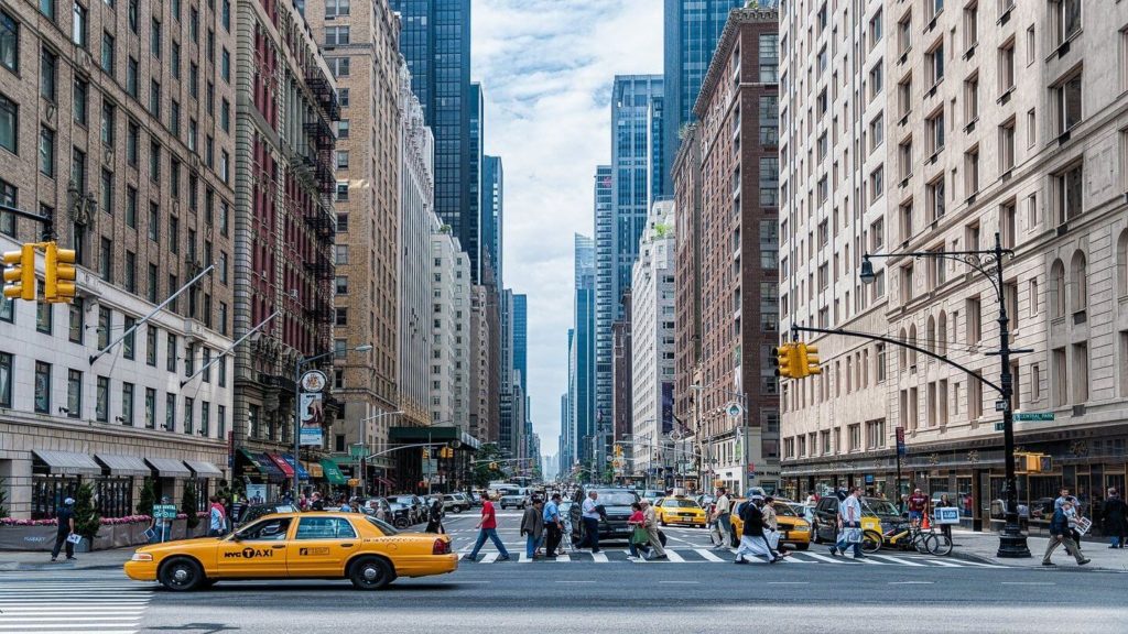 yellow taxi people crossing street New York City