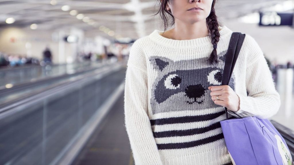 person wearing warm jumper in airport