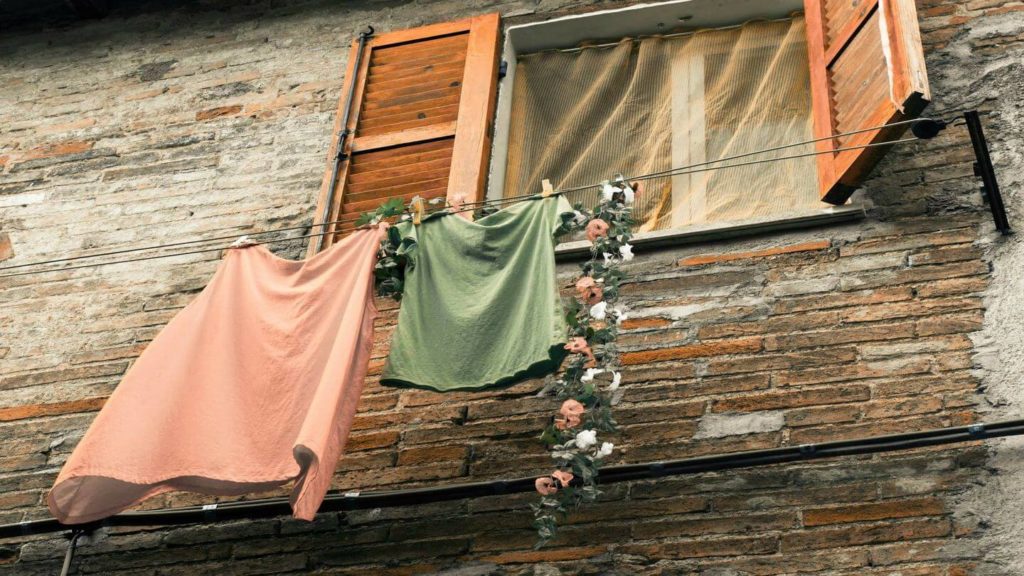 clothes hanging on a line by a window