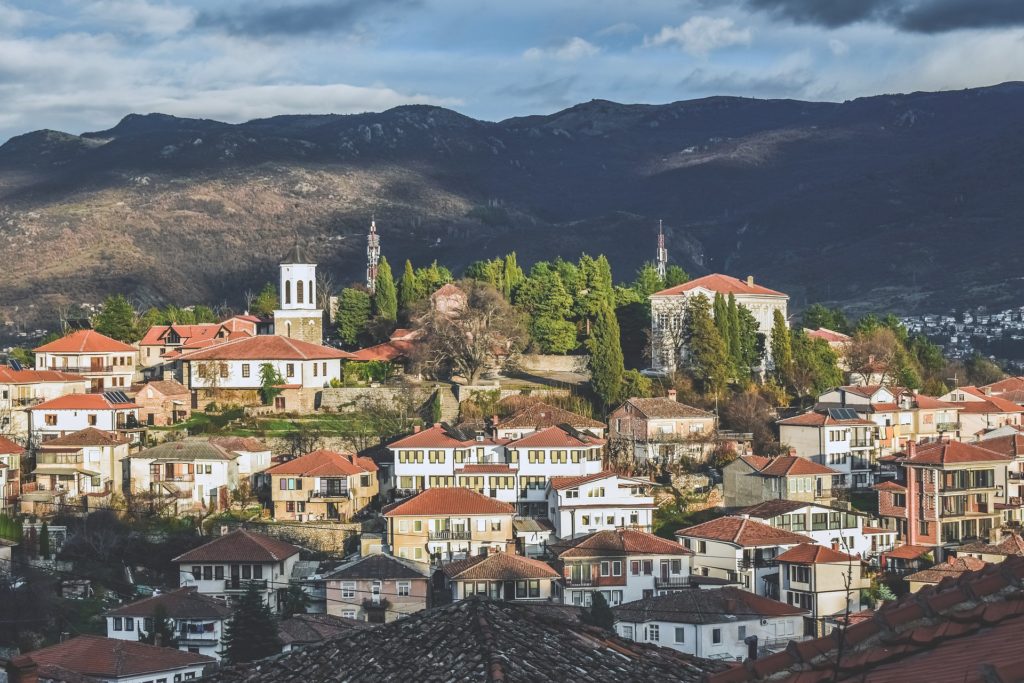 One of the cheapest cities in Europe, North Macedonia boasts red roofs and mountains in the background.