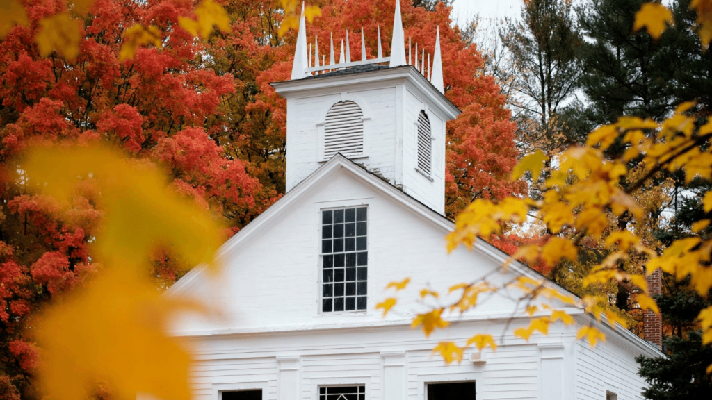 Fall foliage on white church New England