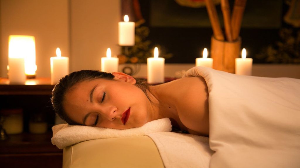 woman getting candle lit hotel massage 
