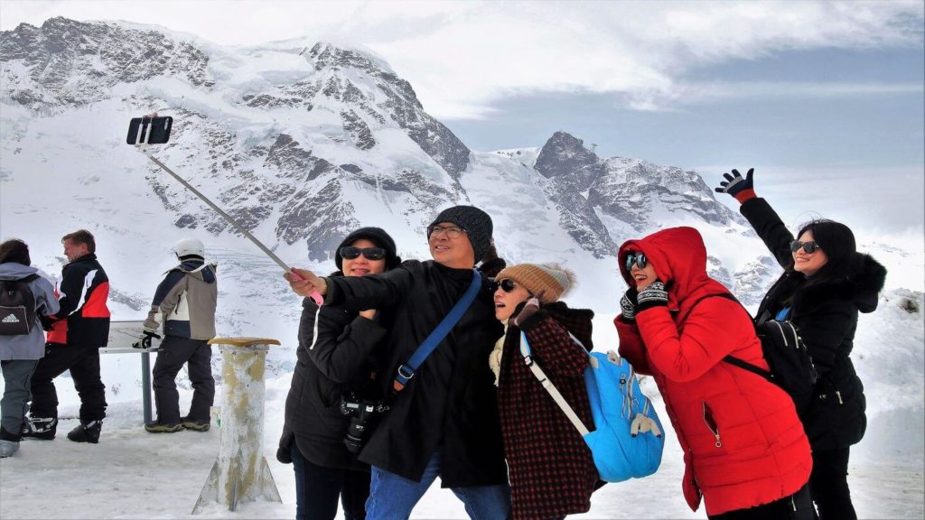 travellers taking a group photo at the snow