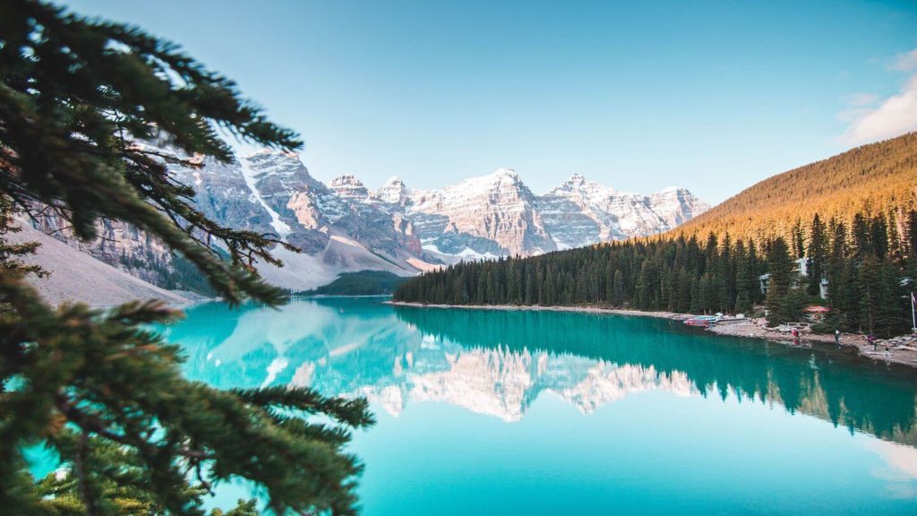 A blue lake surrounded by mountains in Banff National Park, a popular destination for travellers exploring in 2021.