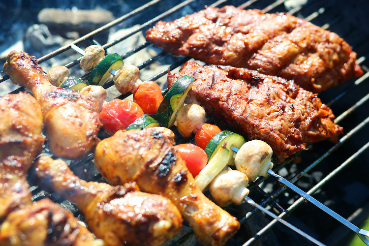 Assortment of meats and vegetables being barbecued