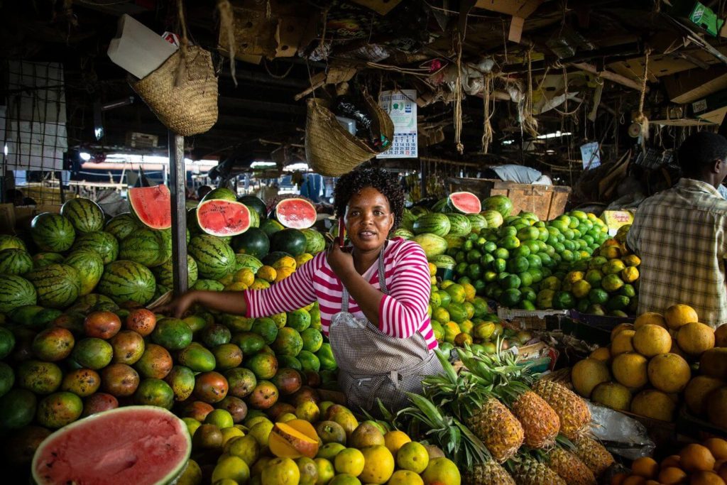 woman in a Nairobi fruit market African Christmas traditions