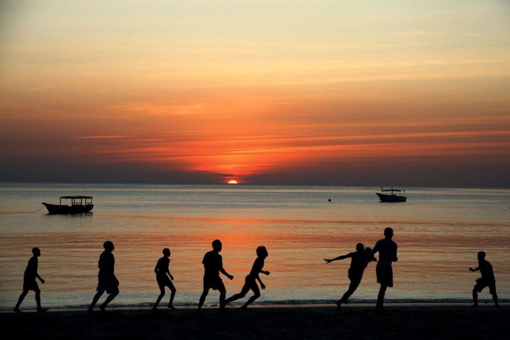 people playing on the beach at sunset Christmas in Zanzibar