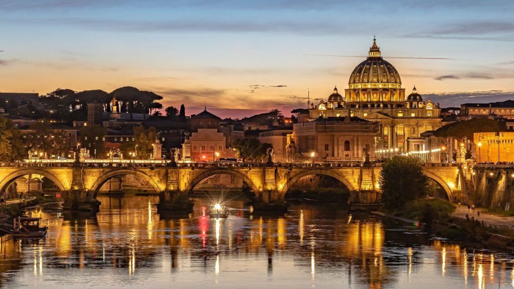 Rome bridge cathedral glowing at night