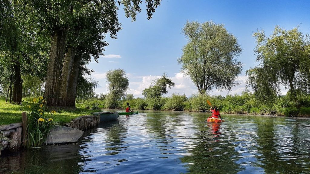 people canoeing down Ljubljana River Slovenia