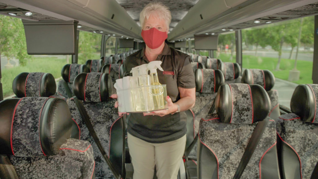 A Trafalgar Wellbeing Director* cleaning a coach