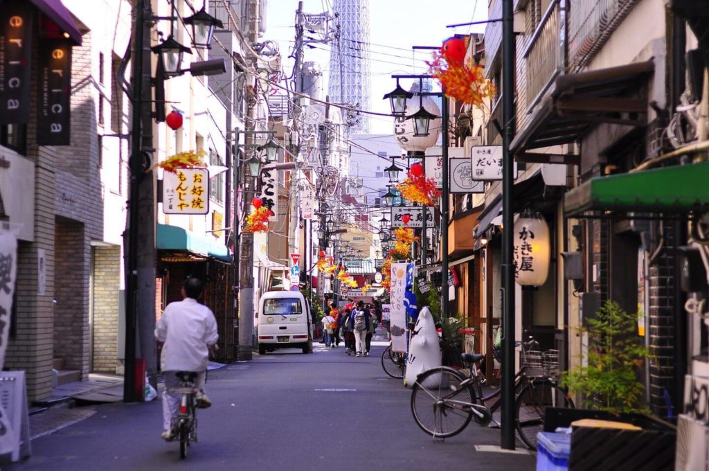 man cycling along a street in Tokyo Japan