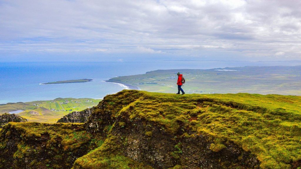 traveller walking through the Scottish Highlands
