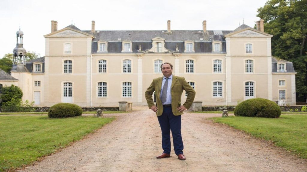 Remy outside his 17th-century mansion in France