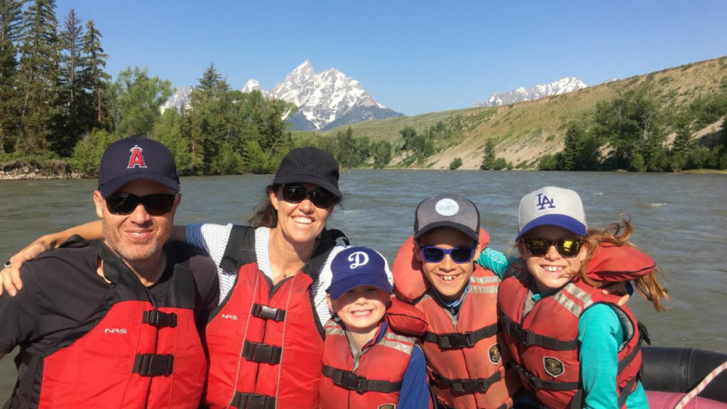 Happy family rafting in North America.