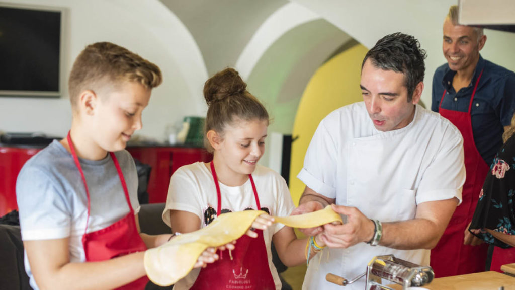 Australian celebrity chef Adam Swanson happily watching his kids learn to make fresh pasta from an Italian chef in Rome.