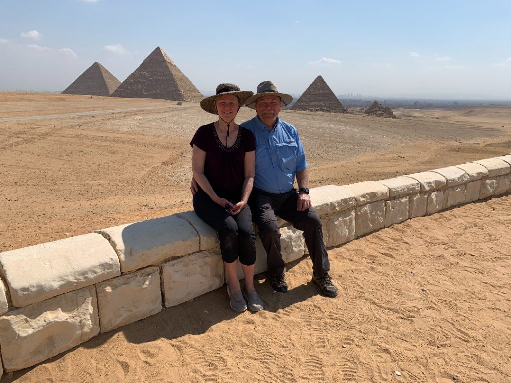 John and Diana Ramsey sitting in front of the pyramids