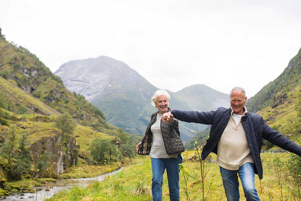 elderly couple exploring the mountains in Scandinavia
