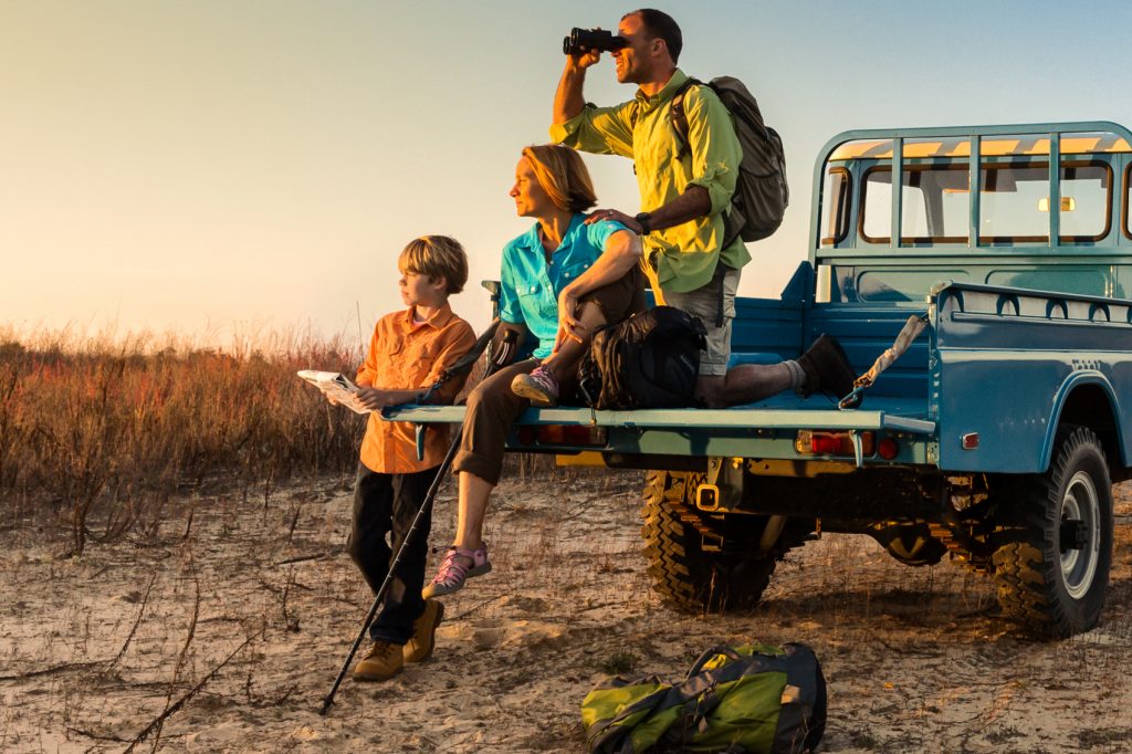family on safari in Africa looking for animals