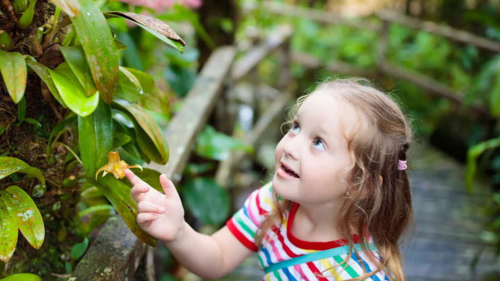 girl looking at a plant Costa Rica
