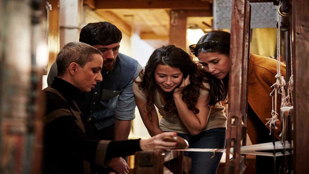 Marta showing Trafalgar guests traditional weaving methods in Italy