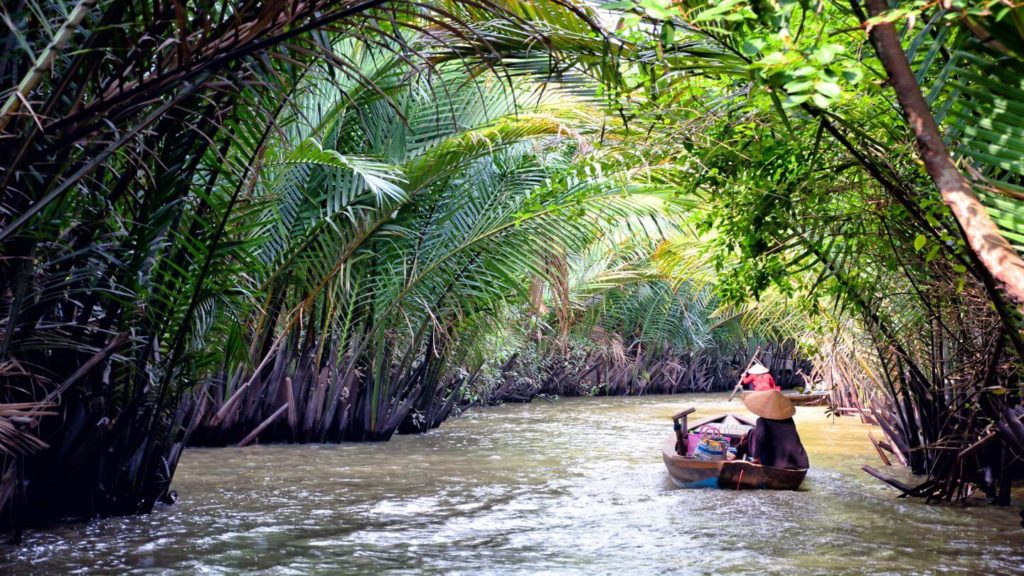 people sailing through the jungle Mekong River