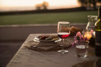 Dinner table in tuscany with wine glass half full