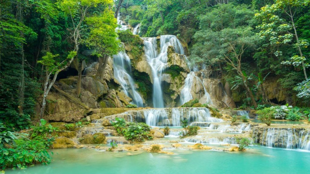 blue waters green jungle Kuang Si Falls Laos