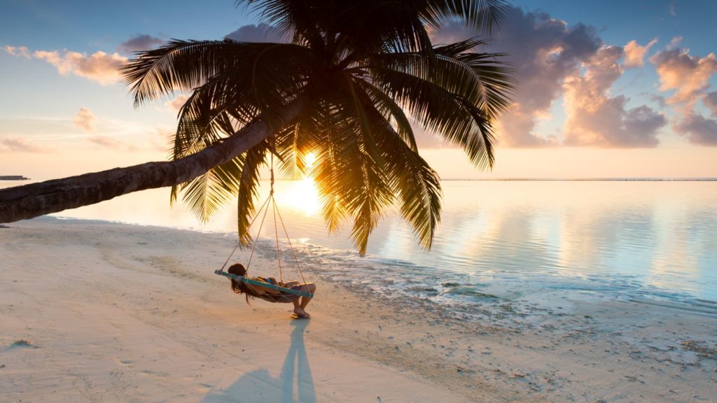 woman relaxing in a hammock on beach