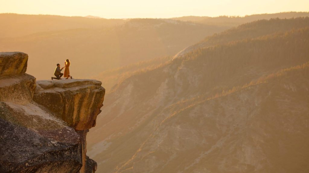 couple proposing on mountain top