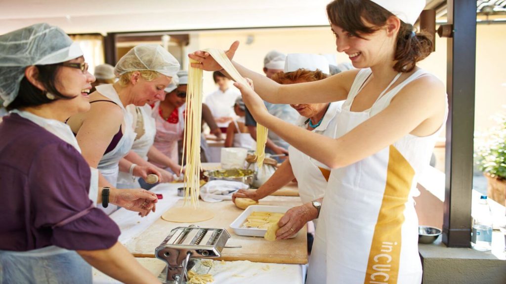 woman learning to cook pasta Trafalgar tour in Florence
