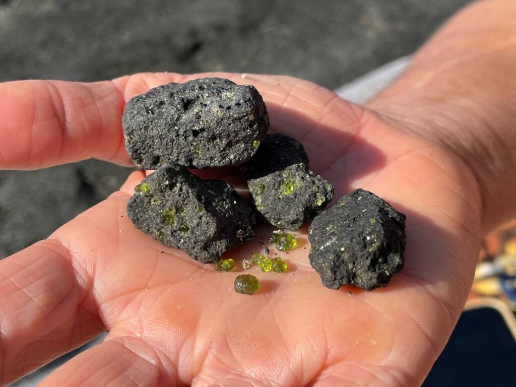 hand holding olivine harnessing the earth’s natural resources