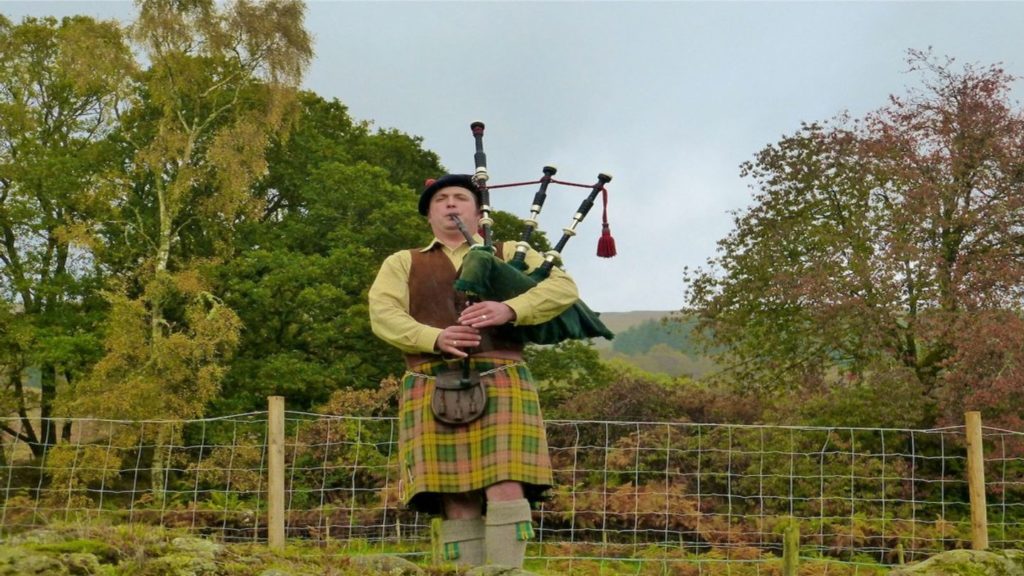 Scottish man playing bagpipes at Ledard Farm