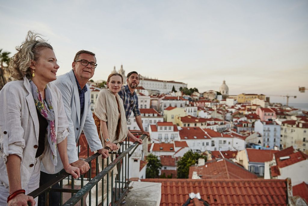 four friends looking out over Lisbon city