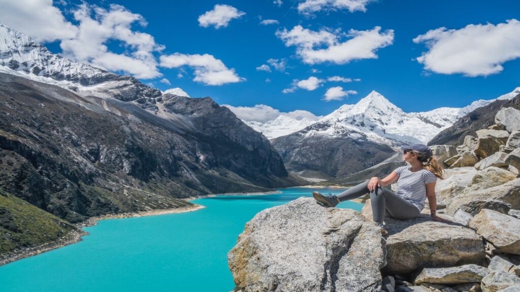 woman sitting by blue lake in Canadian Rockies