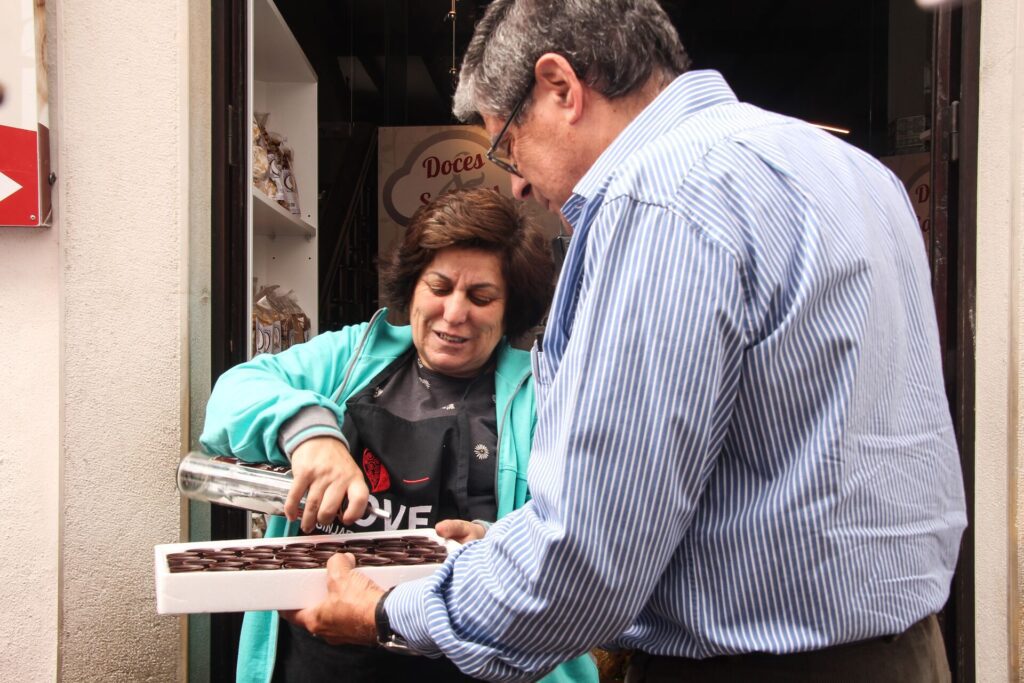 Portuguese woman pouring drinks