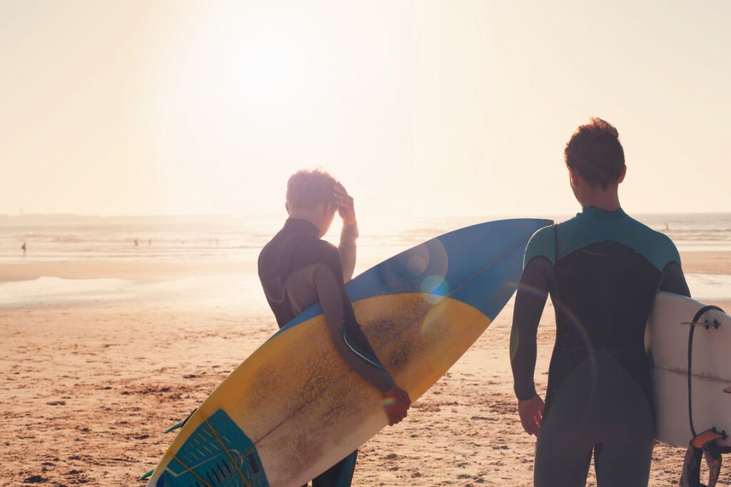 surfers on beach in portugal