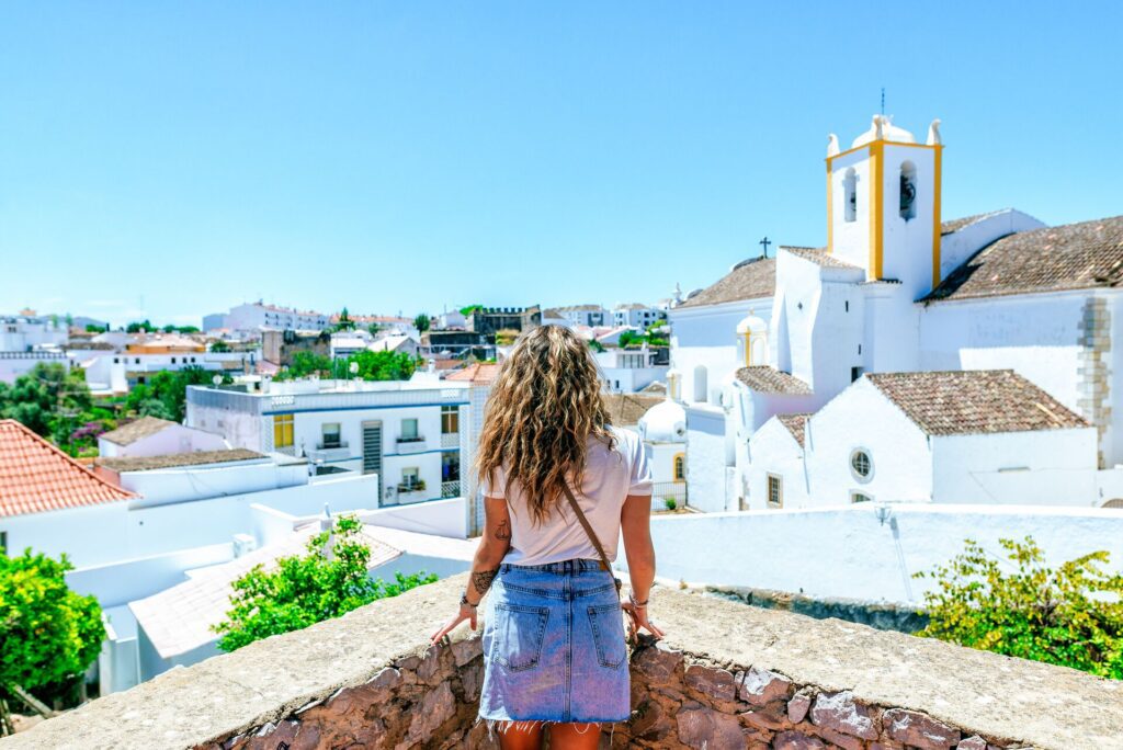 woman looking out at houses in portugal