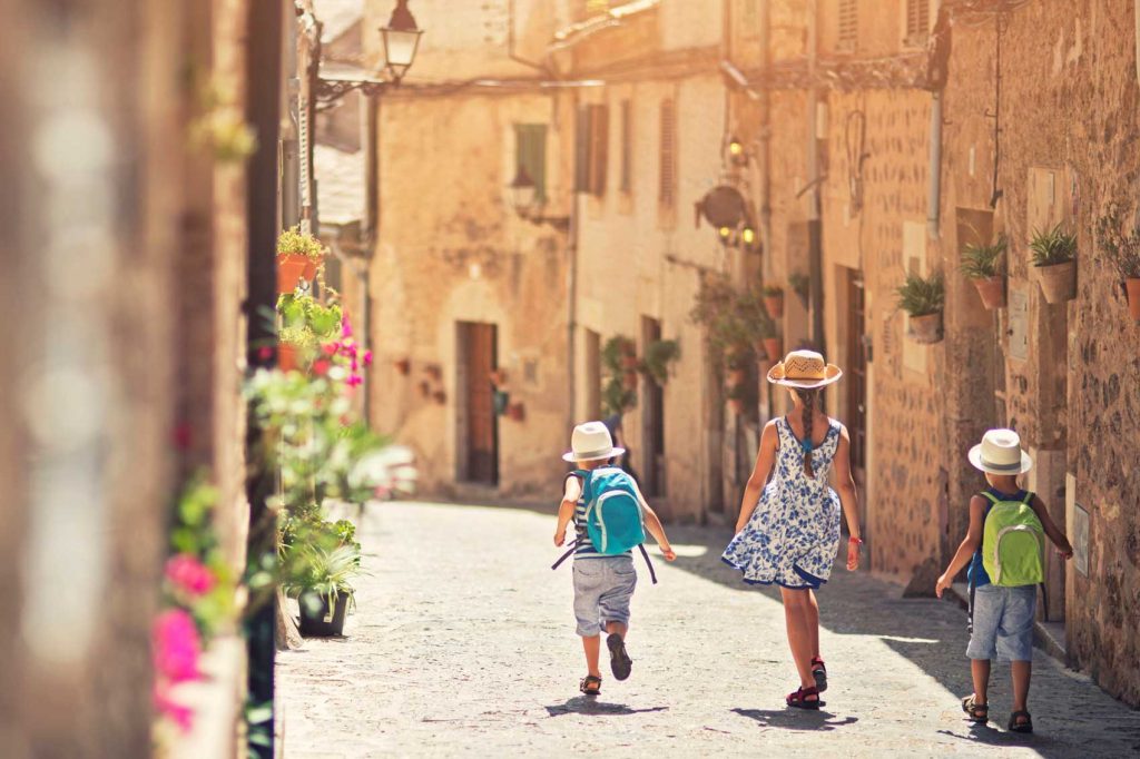 kids walking through streets of Italy