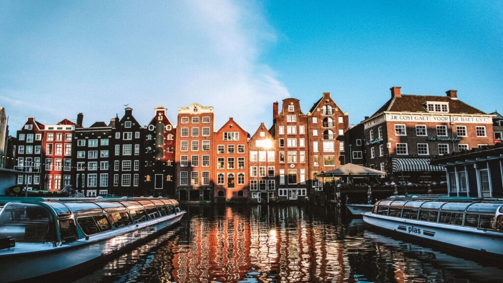 buildings boats canal Amsterdam Netherlands