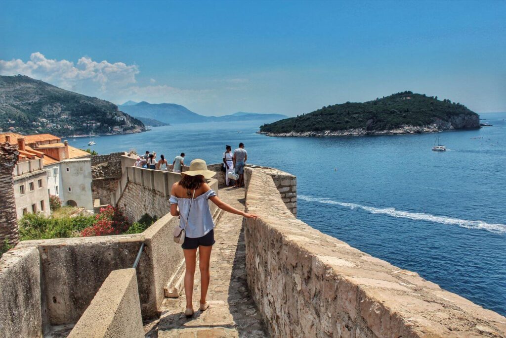 traveler walking along seaside rampart Croatia
