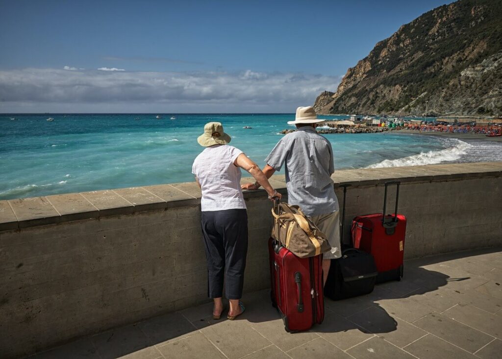 travellers at the beach with suitcases
