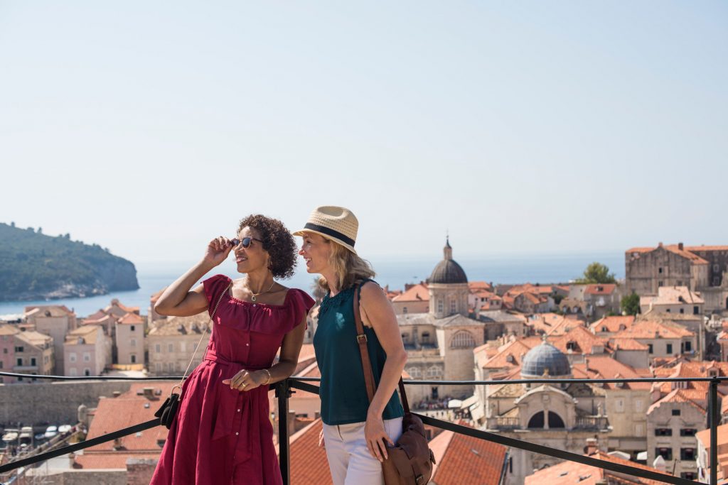 two travellers overlooking the ocean