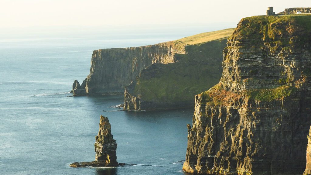 Image of Ireland's Cliffs of Moher - sheer-sided cliffs and a rock stack, with the sea visible in the left of the image