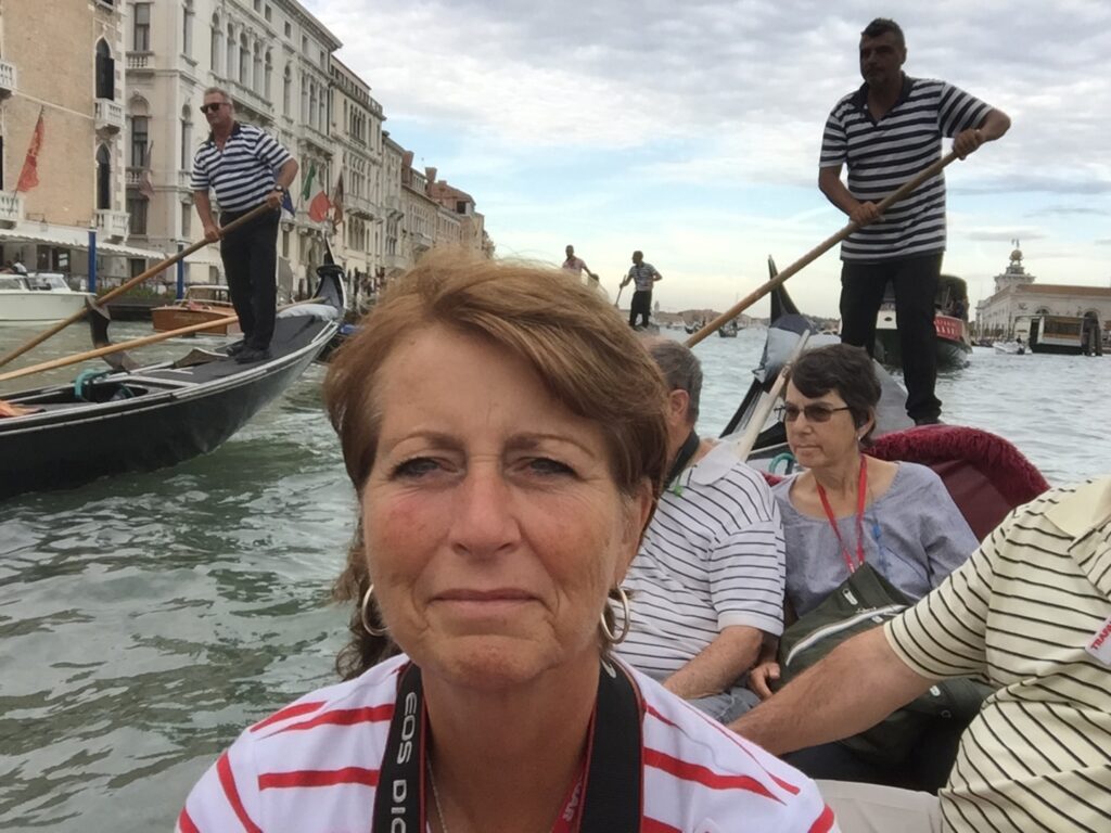 Judy on a gondola ride in Venice on Trafalgar Italy trip