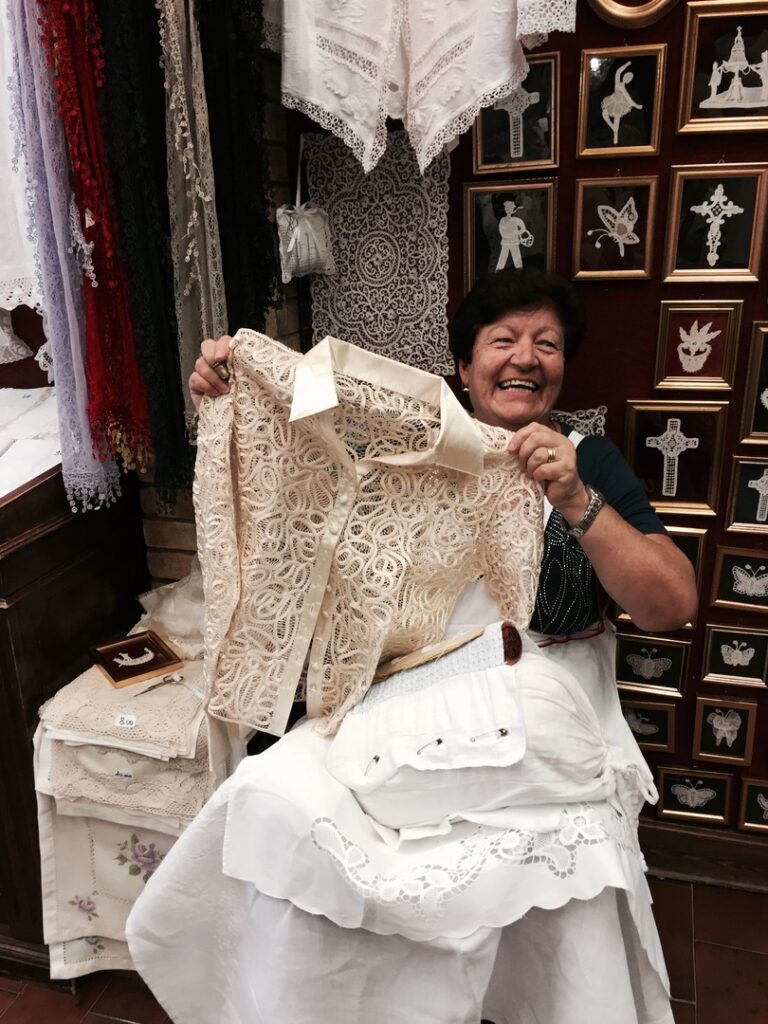 Janet holding lace blouse in Venice on Trafalgar Italy trip