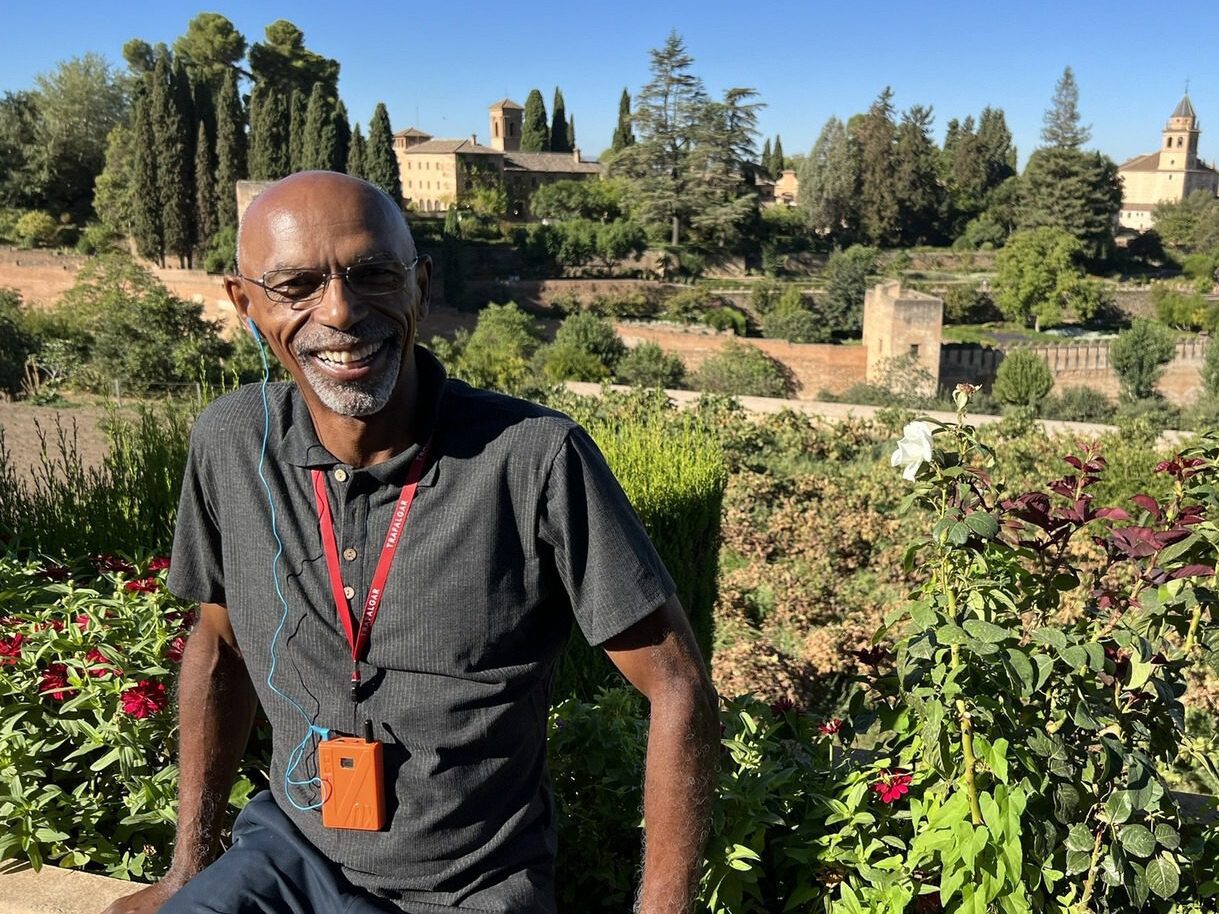 Selfie image of Lawrence with Granada's Alhambra gardens in the background