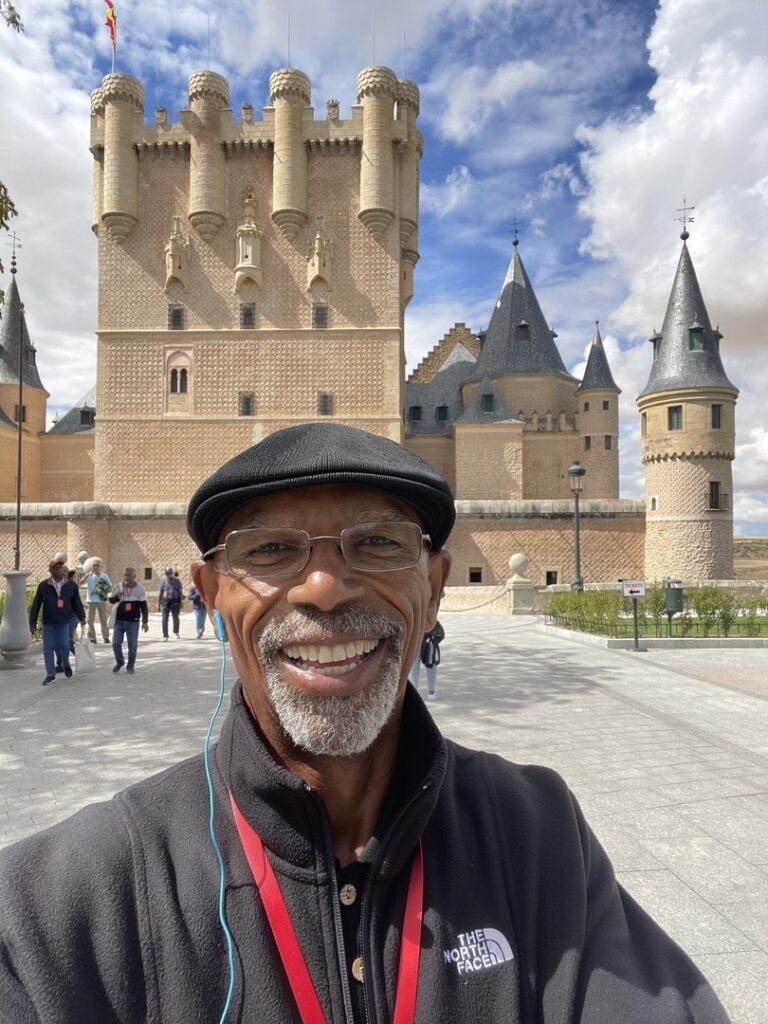 Portrait of Lawrence with a castle in the background 